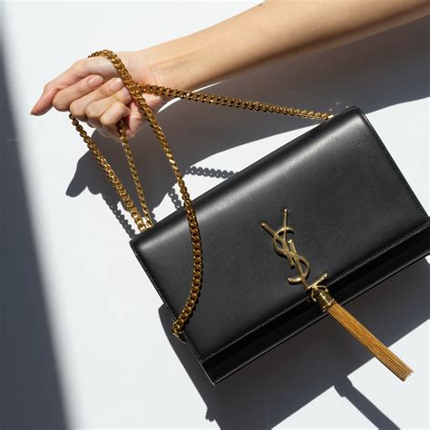 black and gold ysl purse|ysl black purse with tassel.